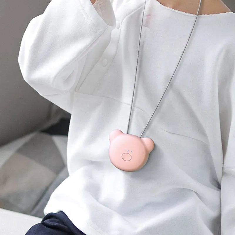 Mini USB portable air purifier necklace in blue, shown next to its charging cable.