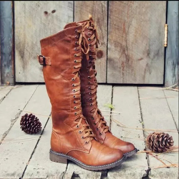 Women's black chunky heel high-leg ankle boots with a round toe on a plain background.