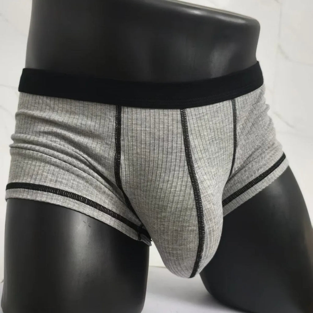 Men's thin fabric boxer shorts in solid colours showing hip lifting design