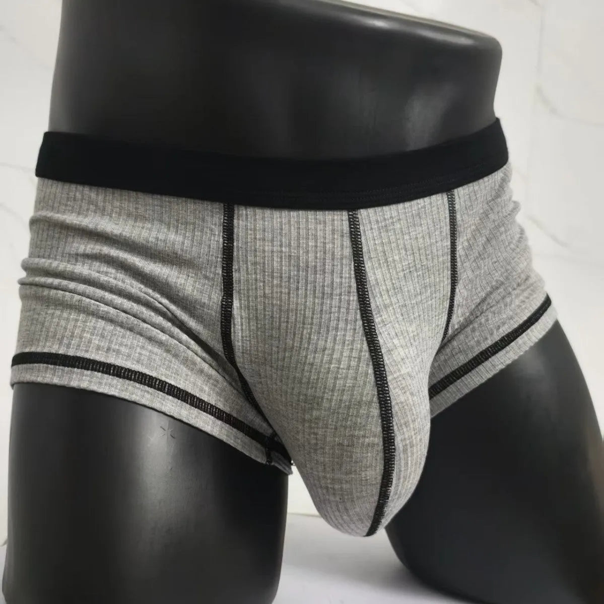Men's thin fabric boxer shorts in solid colours showing hip lifting design