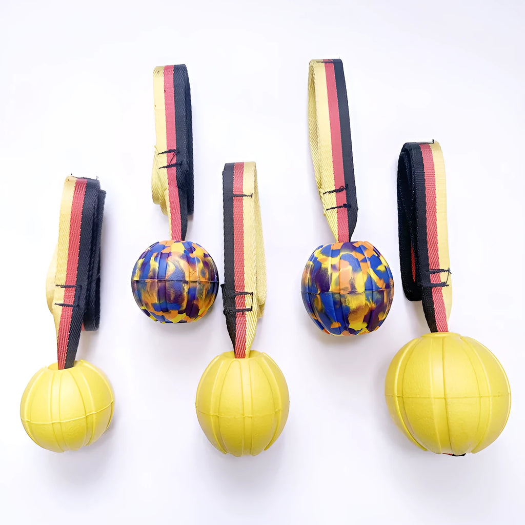 Floating EVA tetherball dog toy in yellow with attached retrieval string on water surface
