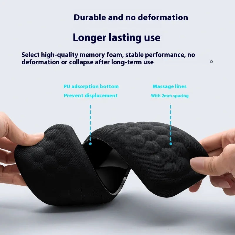 Black memory foam mouse wrist pad with silicone bottom on a wooden desk
