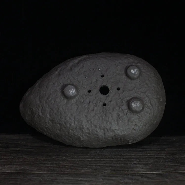 Handmade purple clay flower pot showing unique shape and texture with floor-standing design