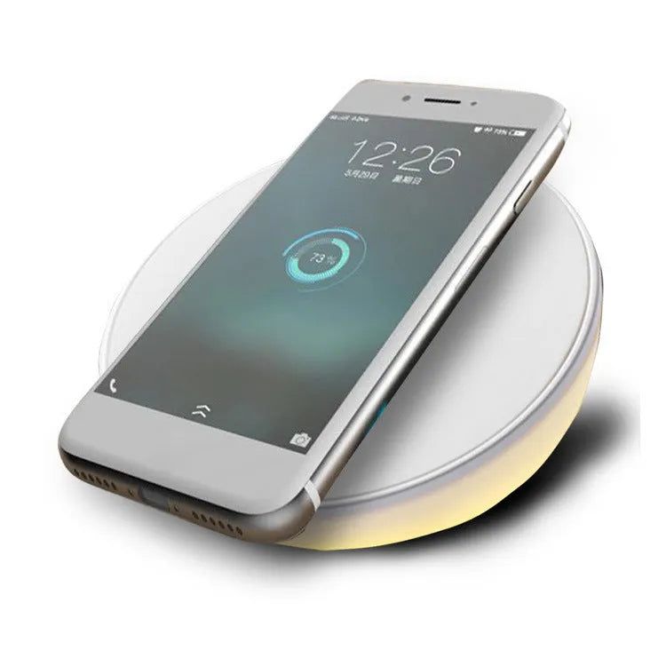 White rectangular wireless charging pad with a digital clock display on the front.