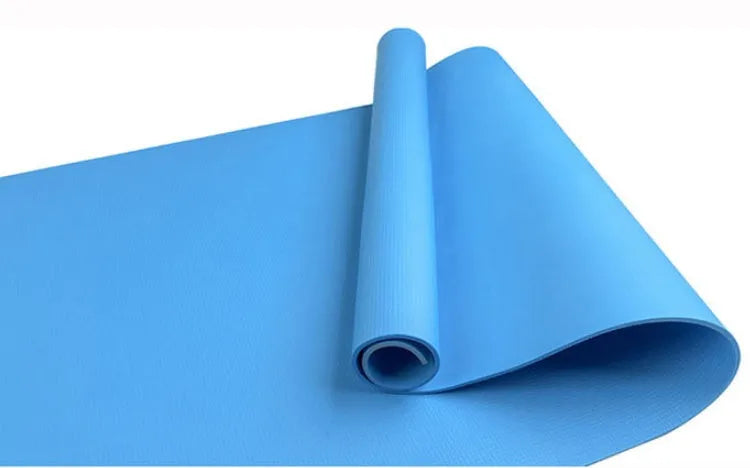 EVA fitness yoga mat in blue, showing its texture and thickness, rolled up with its OPP storage bag.