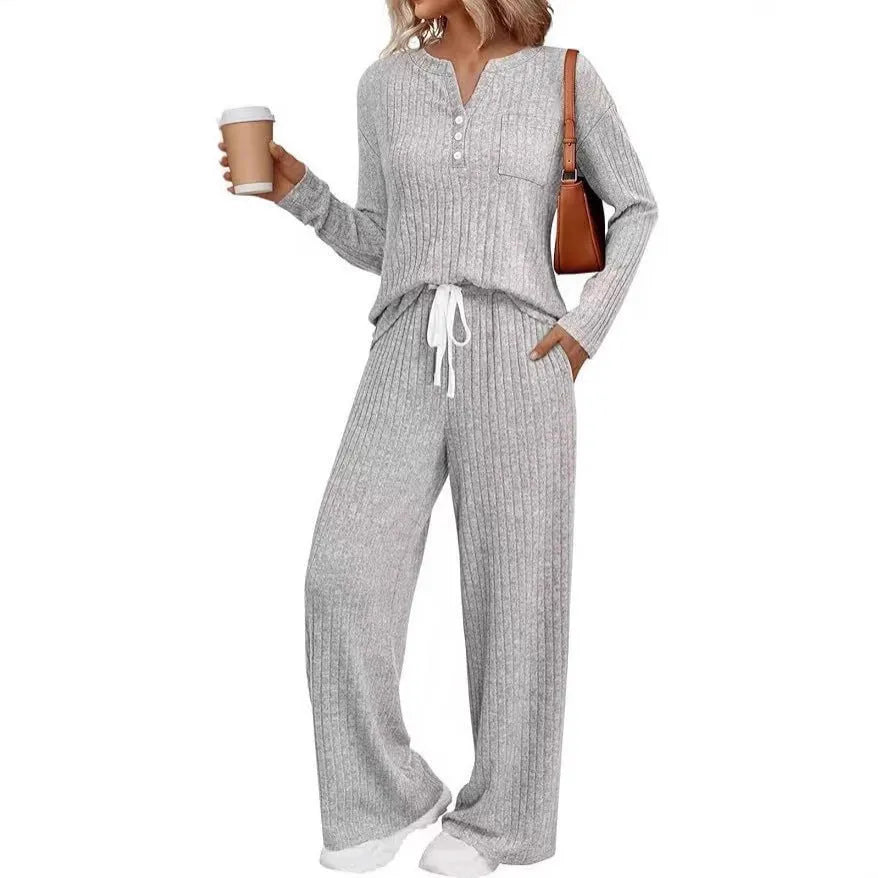 Women's striped knitted long coat with V-neck, long sleeves, lace-up detail, and side pockets.