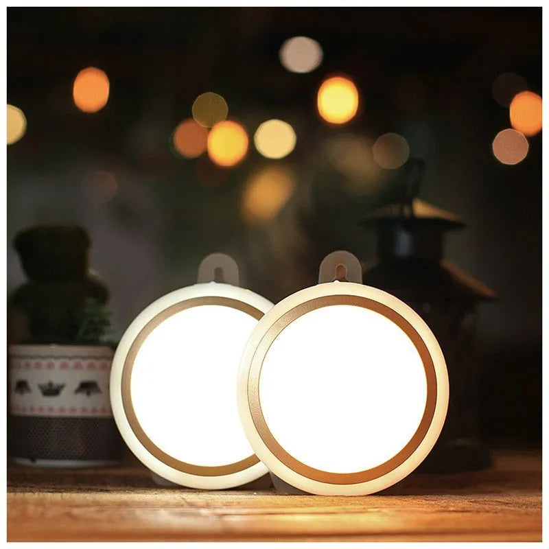 Wireless round motion sensor LED light with white plastic housing, shown mounted inside a wardrobe.