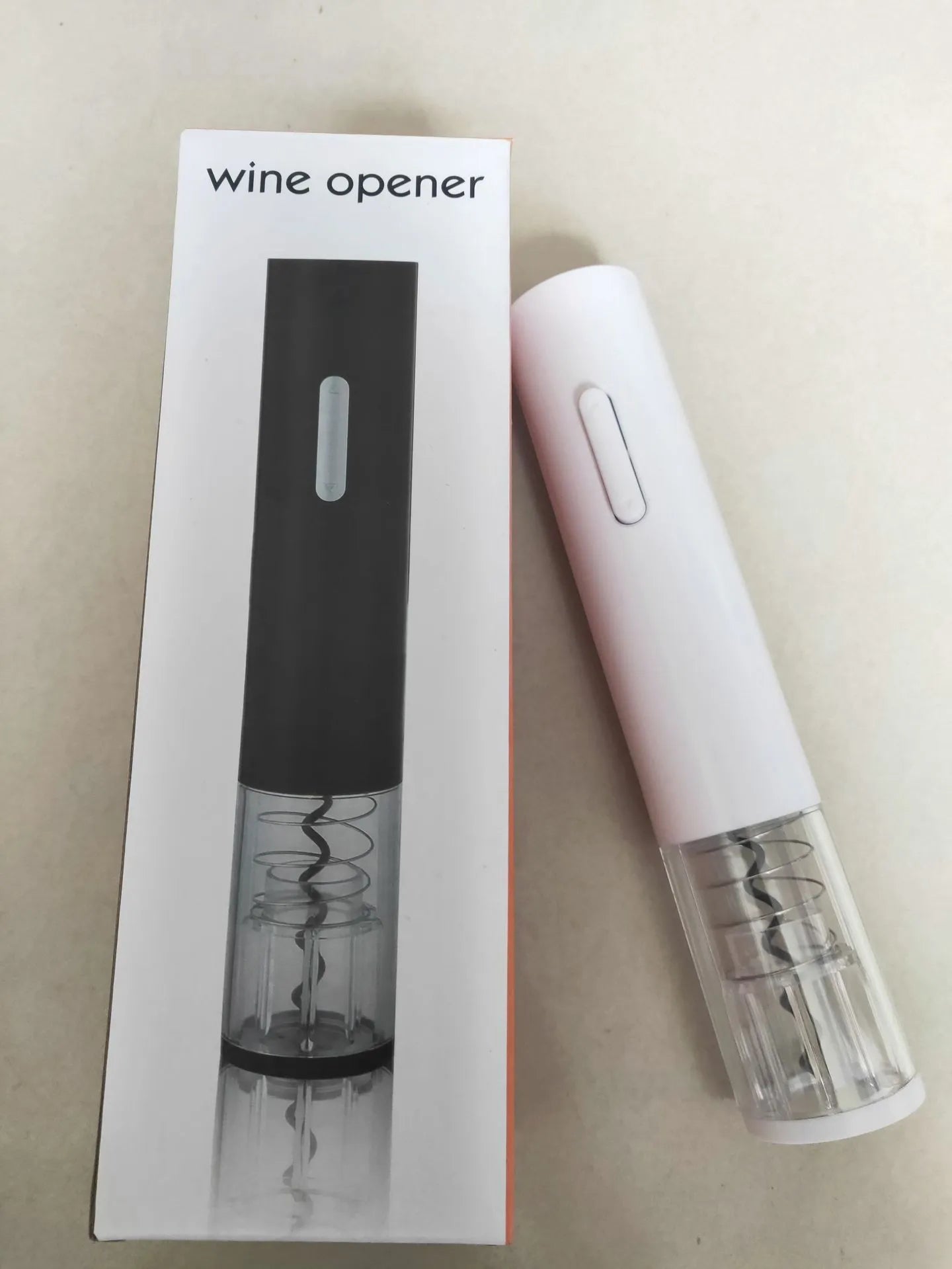 Black automatic electric wine bottle opener with foil cutter on a counter