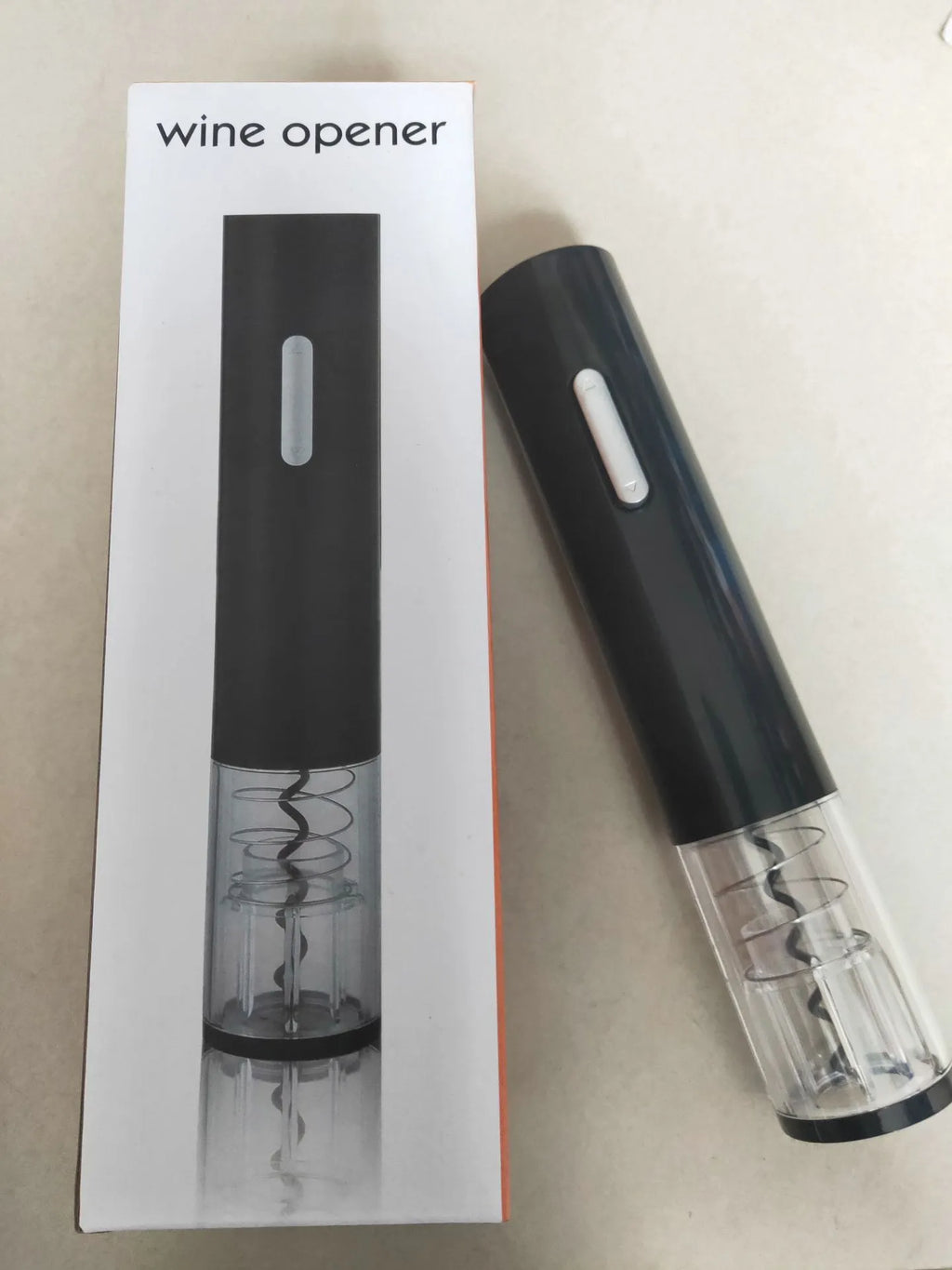 Black automatic electric wine bottle opener with foil cutter on a counter