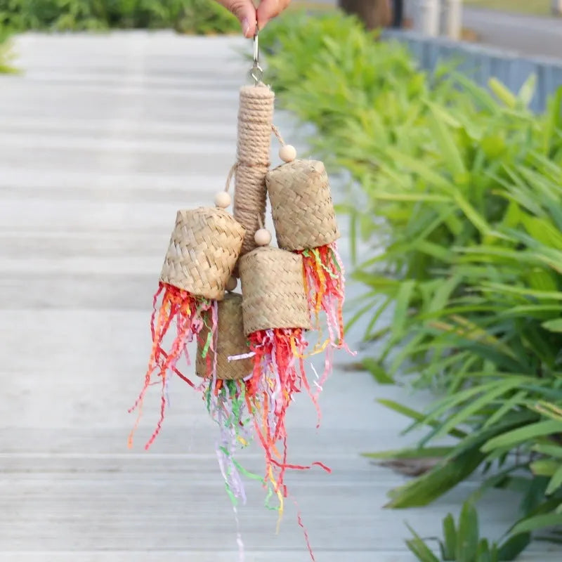 Wood and sisal parrot toy with colourful shredded paper measuring 15cm by 35cm