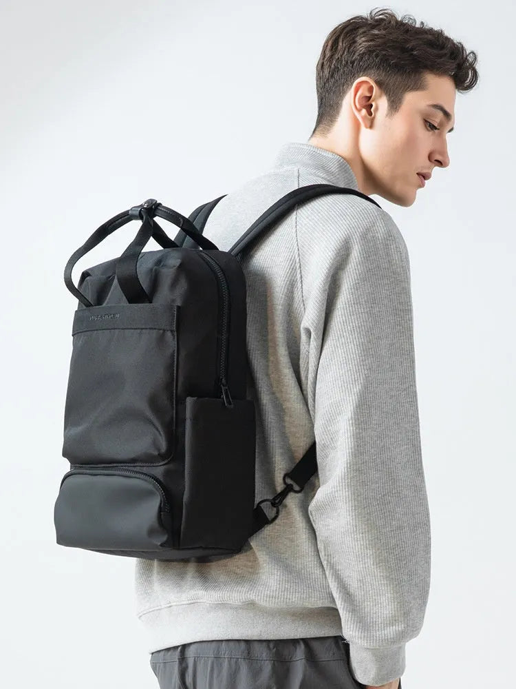 Black Oxford cloth computer backpack showing main compartment and 20-35L capacity.