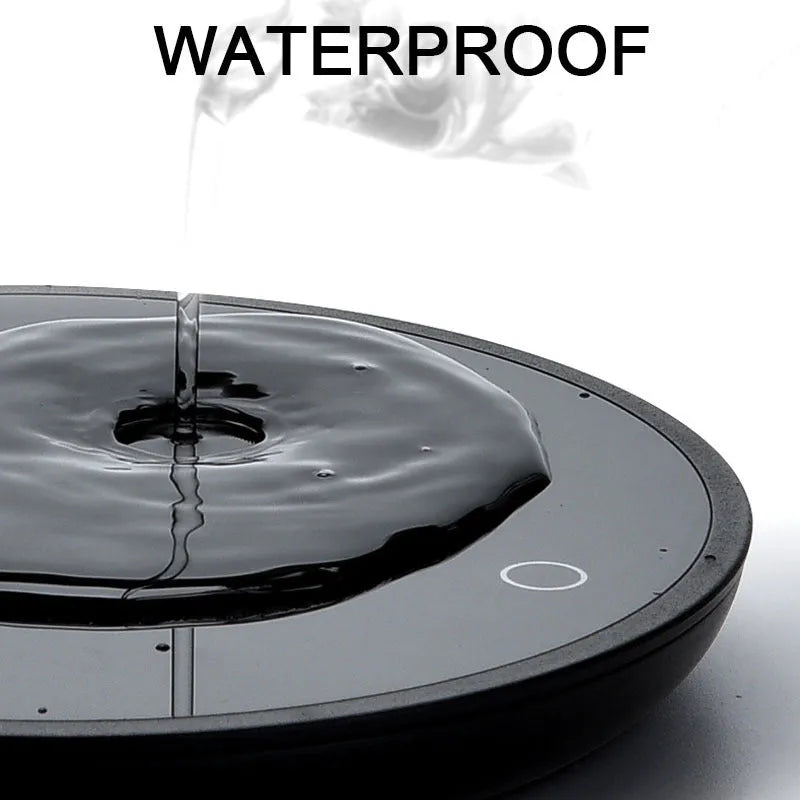 Black circular mug warmer with tempered glass surface and temperature switch