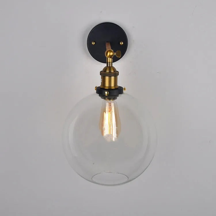 20cm round retro glass wall lamp in amber colour with aluminium holder on a white wall.