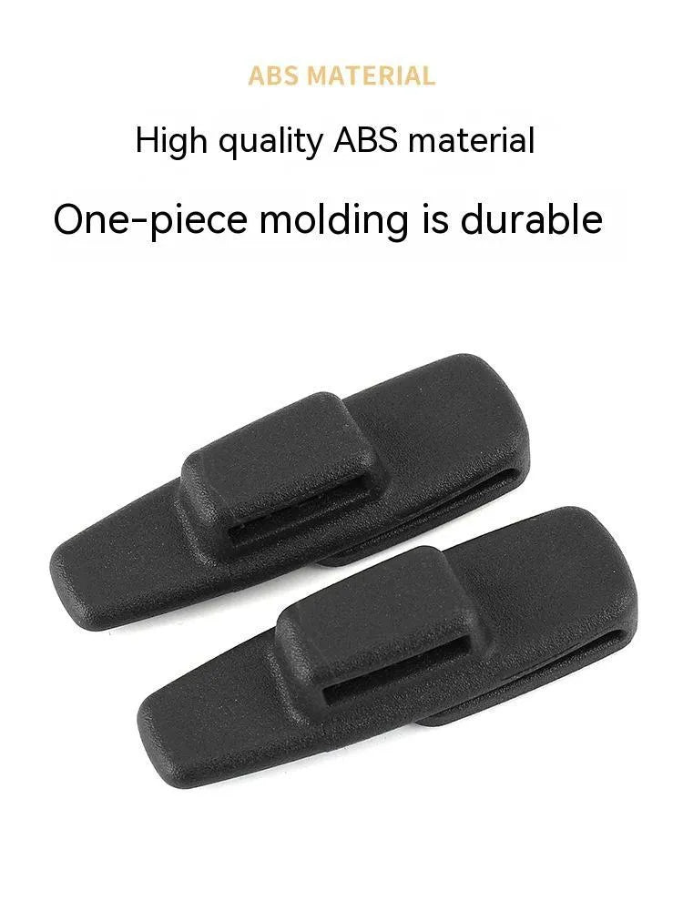 Black ABS plastic car seat belt stopper clips showing universal design for automotive use