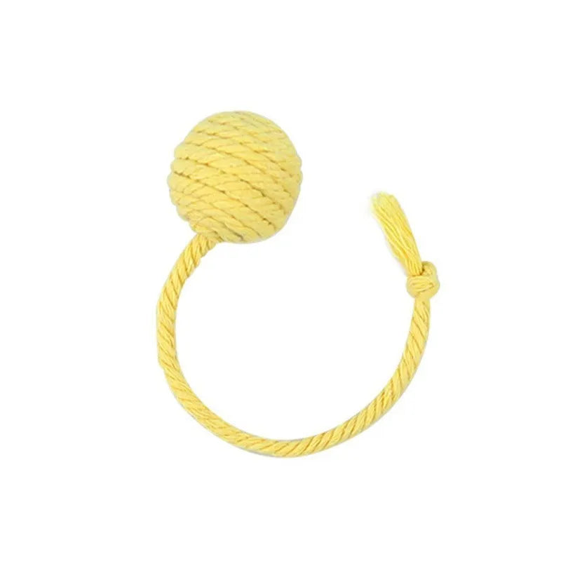 Green cat toy ball with a rope handle looped through it, shown next to a smaller pink version.