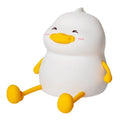 Chubby Night Light desk lamp showing soft glow, phone holder slot, and compact silicone design.