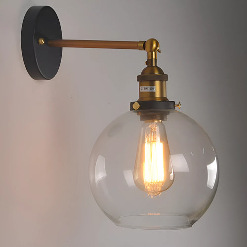 20cm round retro glass wall lamp in amber colour with aluminium holder on a white wall.
