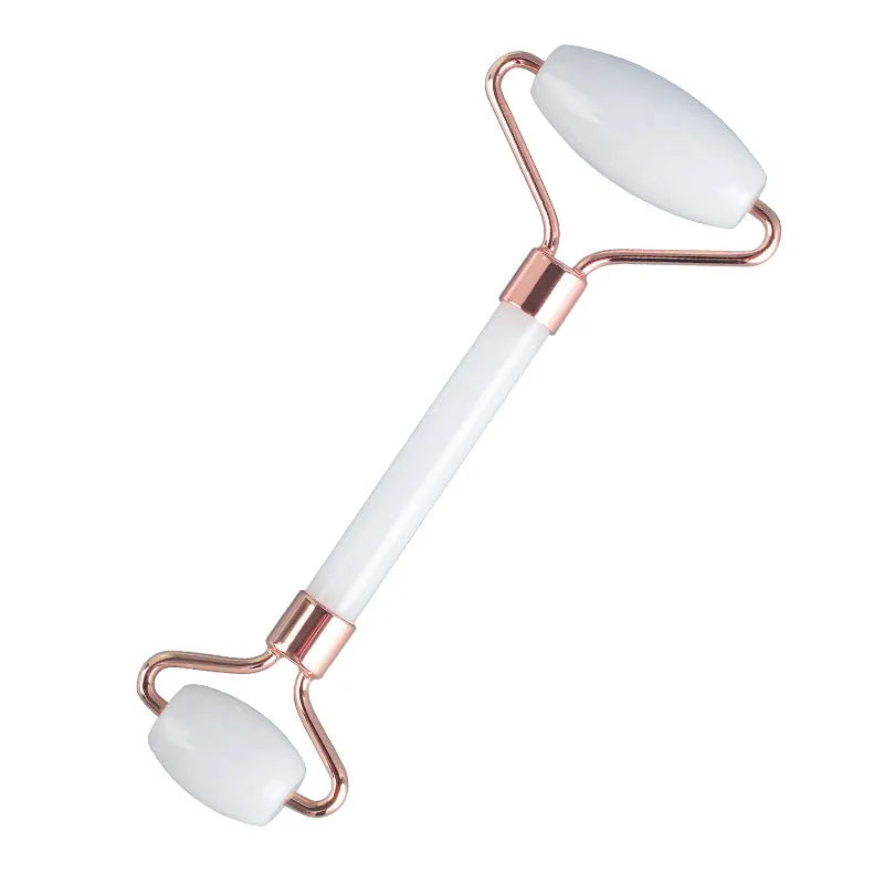 Natural white jade double-headed facial roller and matching scraping board set on a flat surface.