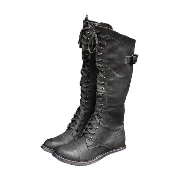 Women's black chunky heel high-leg ankle boots with a round toe on a plain background.