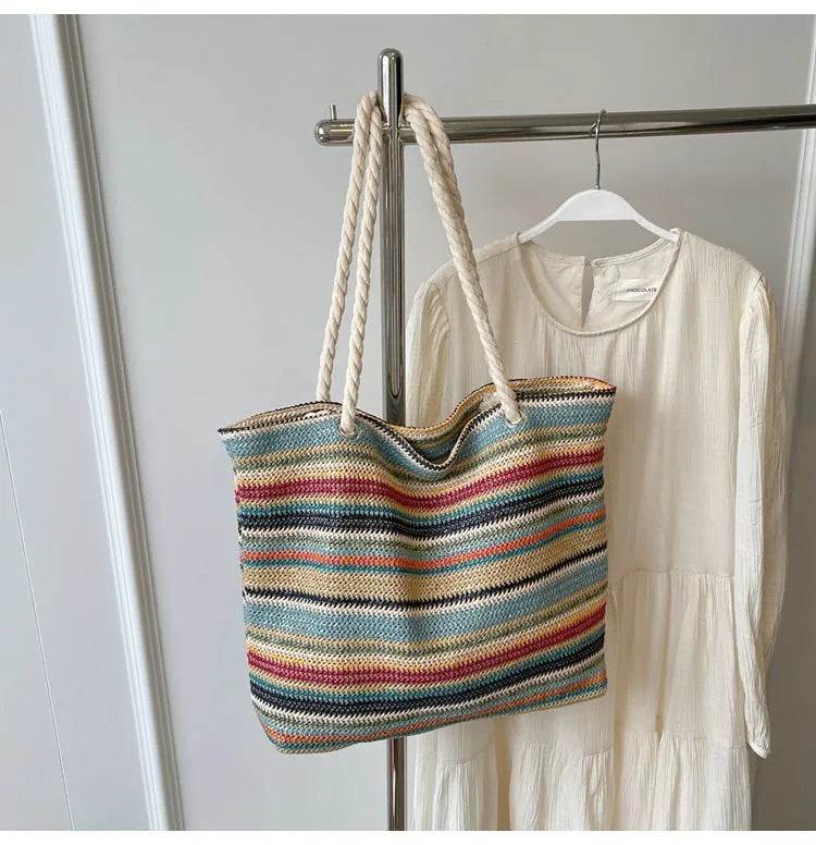 Blue woven straw-effect nylon shoulder bag with a single strap and large main compartment.