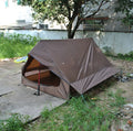 Brown A-line cabin tent setup with hiking pole supports showing spacious interior and waterproof fabric construction