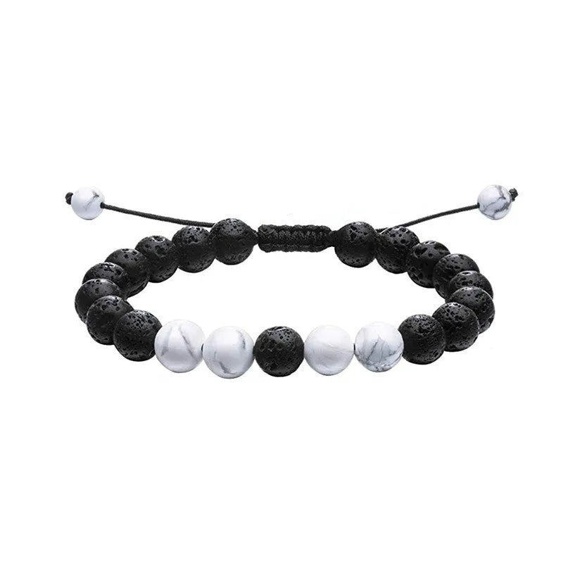 Matte black agate tiger eye bead couple bracelets with geometric design on a neutral background.