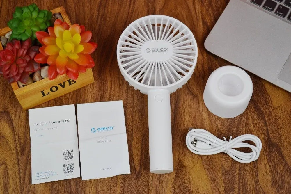White ORICO FH1 portable USB rechargeable desk fan showing three-speed buttons and compact design