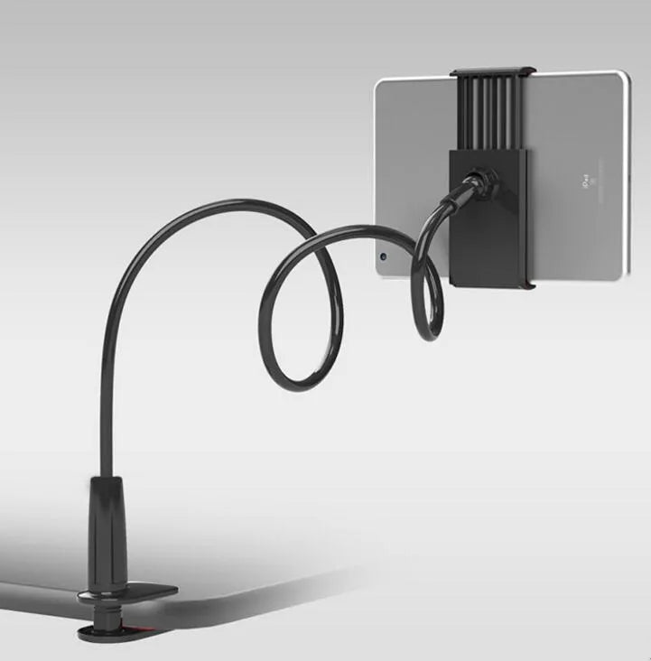 Black bedside oversize flat panel phone holder with a long arm mounted on a table.