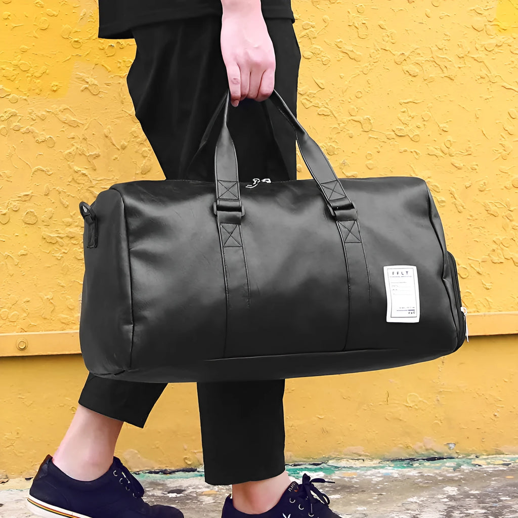 Black waterproof sports duffel bag with separate shoe compartment and diagonal shoulder strap