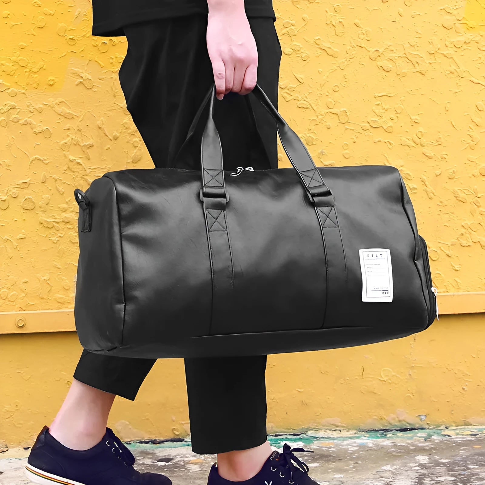 Black waterproof sports duffel bag with separate shoe compartment and diagonal shoulder strap