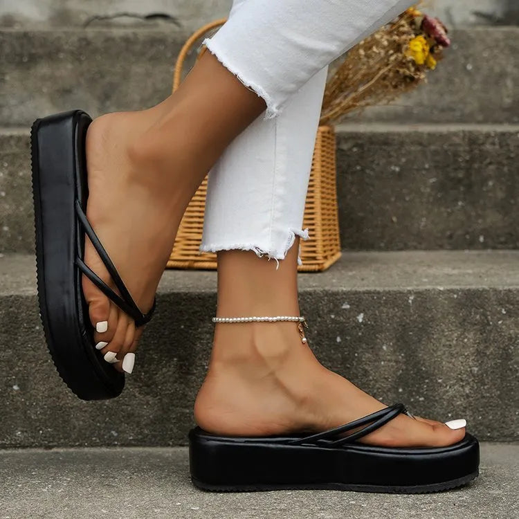 A pair of thick-soled flip-flops in a herringbone strap design, shown in one of six available colours.