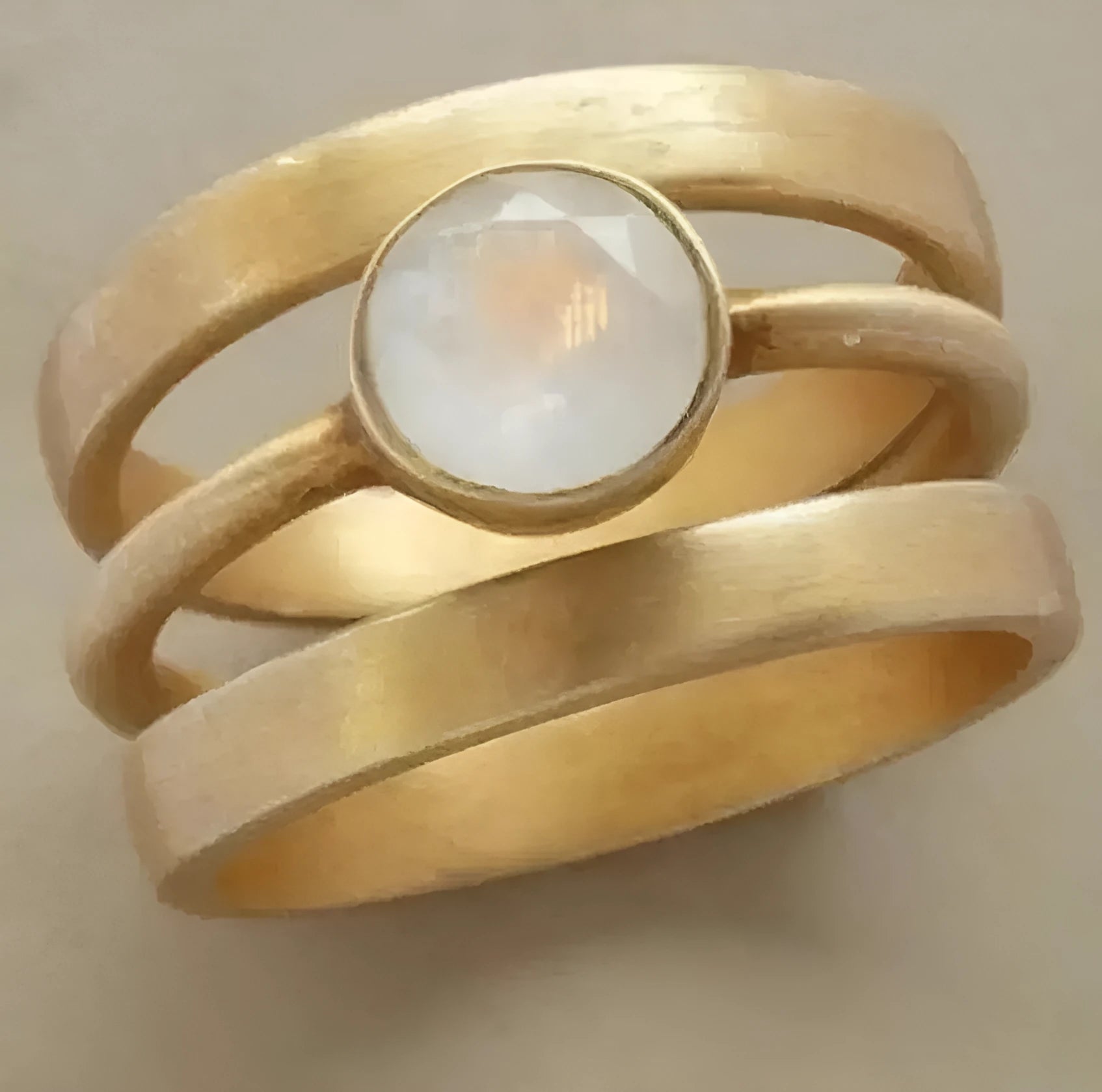 Gold plated geometric ring with micro-inlaid white chalcedony stone on a simple band.