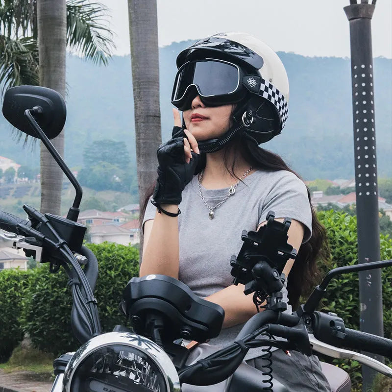 Retro style motorcycle helmet in matte black on a stand, showing classic biker design.