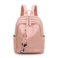 Black women's casual nylon backpack showing square vertical shape with shoulder straps and external pockets