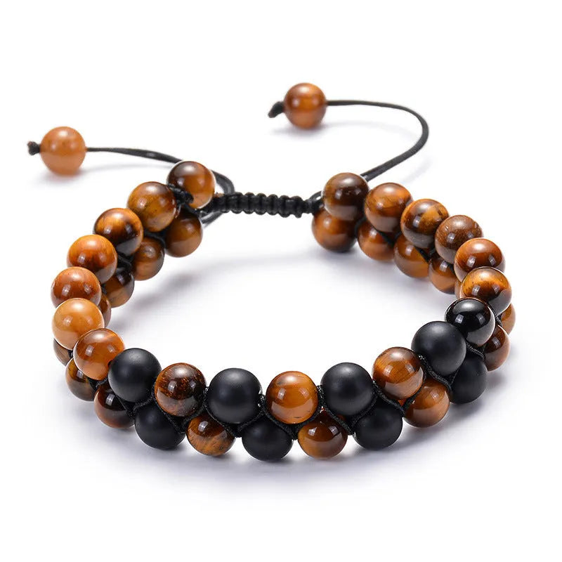 Matte black agate tiger eye bead couple bracelets with geometric design on a neutral background.