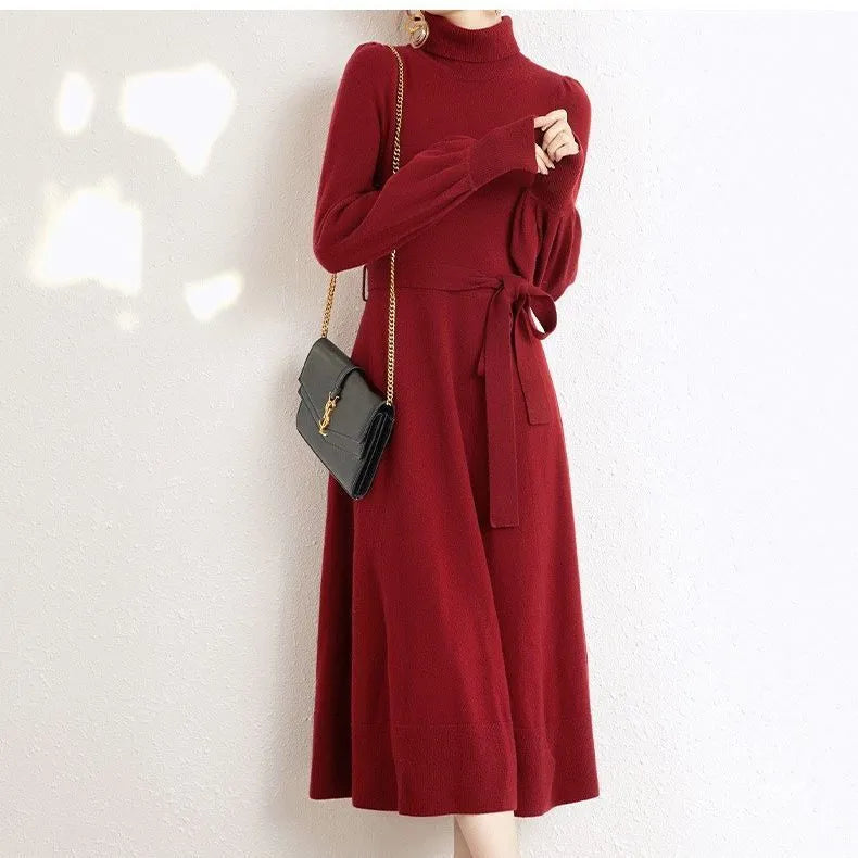 Rose red turtleneck knit dress with long sleeves, elastic waist, and a loose flowing mid-length skirt.