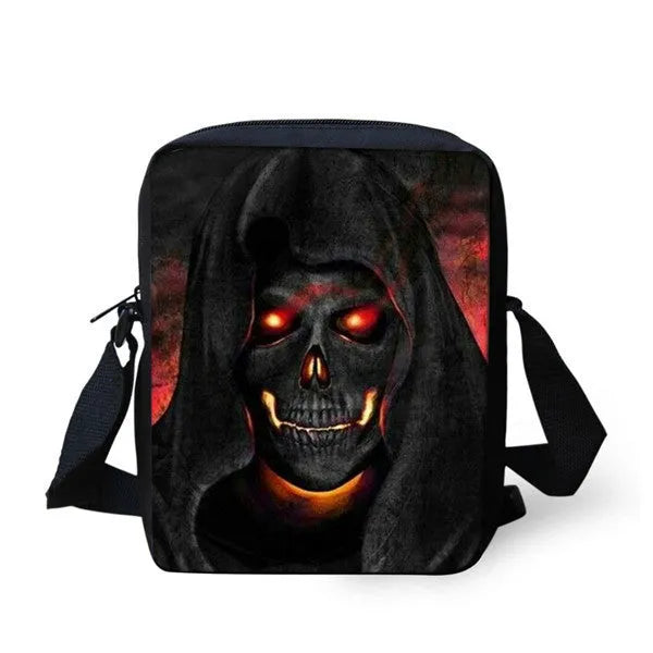 A medium-sized black children's messenger bag with a white skull graphic, showing the double straps and front zipper pocket.