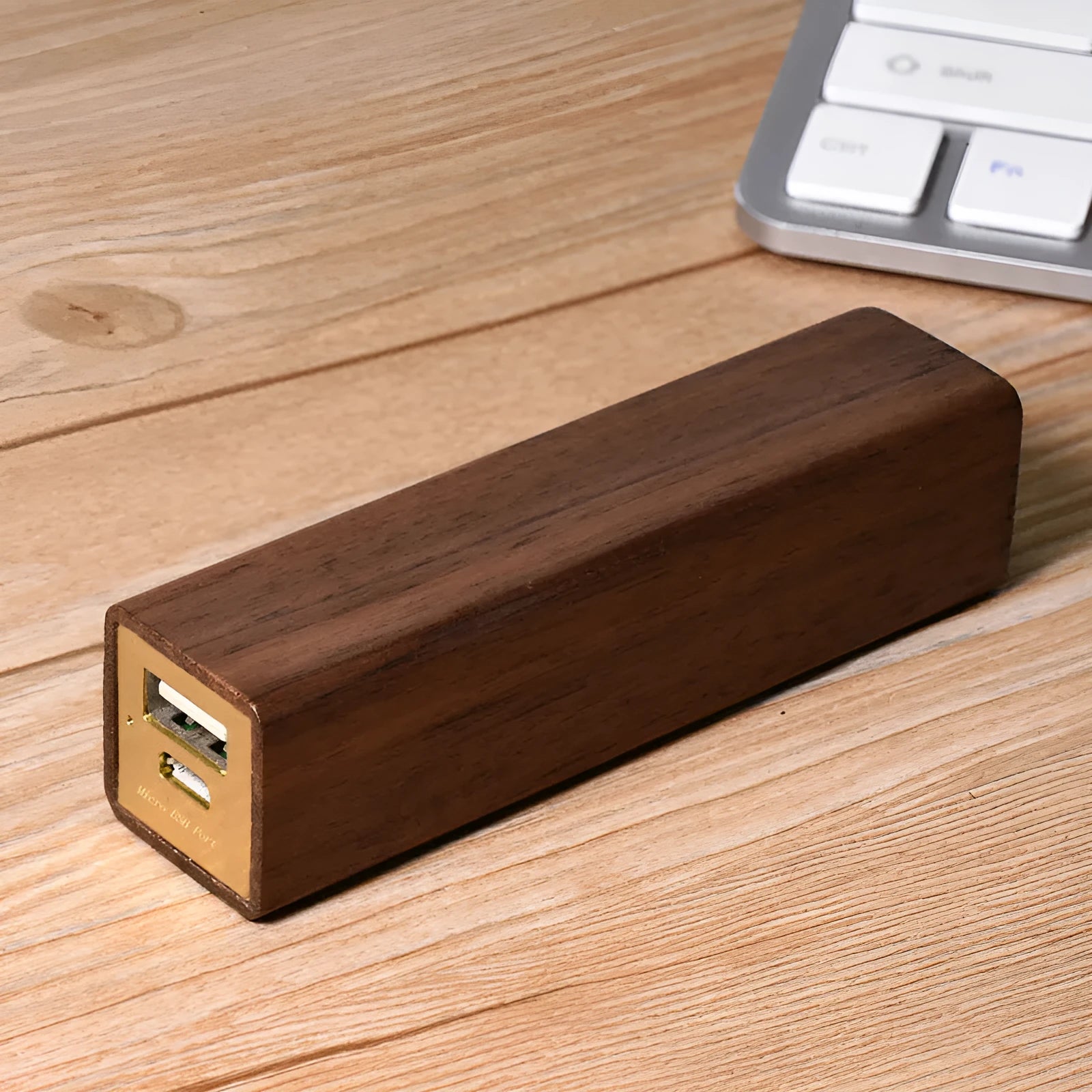 Brown walnut wood portable power bank with dimensions 100mm by 25mm.