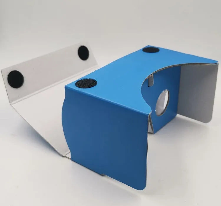 Flat-pack DIY VR cardboard glasses kit for 6-inch smartphones with 3D lenses, rubber band, and velcro strap.