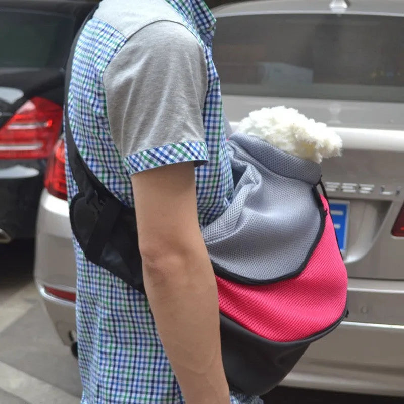Blue polyester pet carrier backpack shown from the side, with mesh panel and straps.
