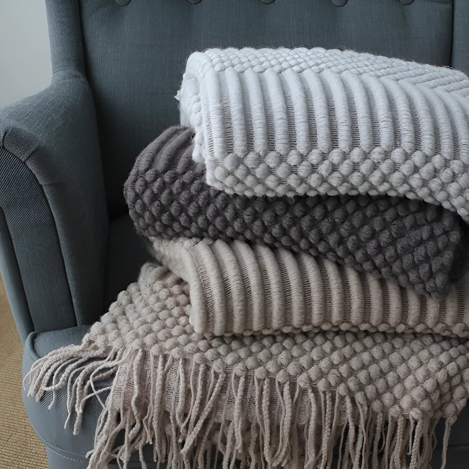 Light grey polyester nap blanket measuring 127cm by 170cm laid flat.