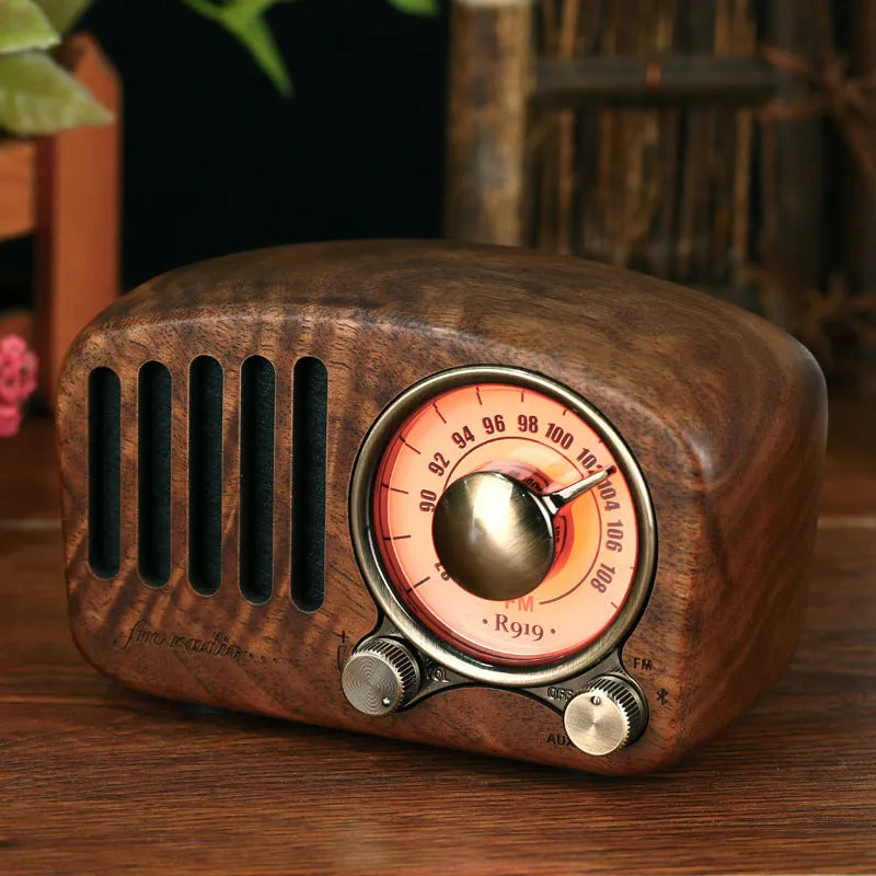 Retro wooden wireless mini Bluetooth speaker in cherry wood finish showing front speaker grille and controls