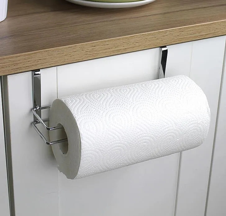 Silver stainless steel paper towel holder mounted on a kitchen cabinet door.