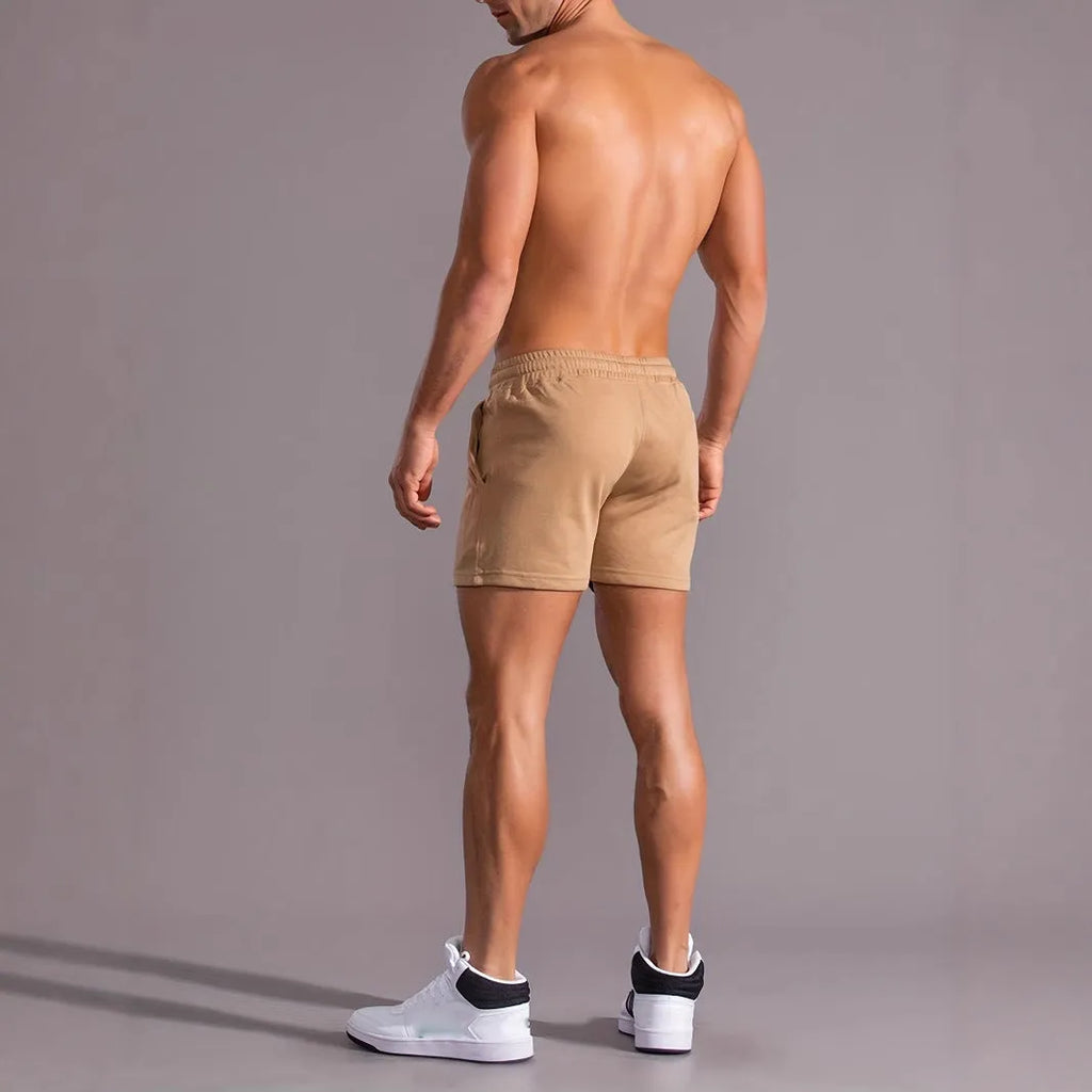 Khaki men's sports shorts with a white coconut leaf print, showing straight leg fit.