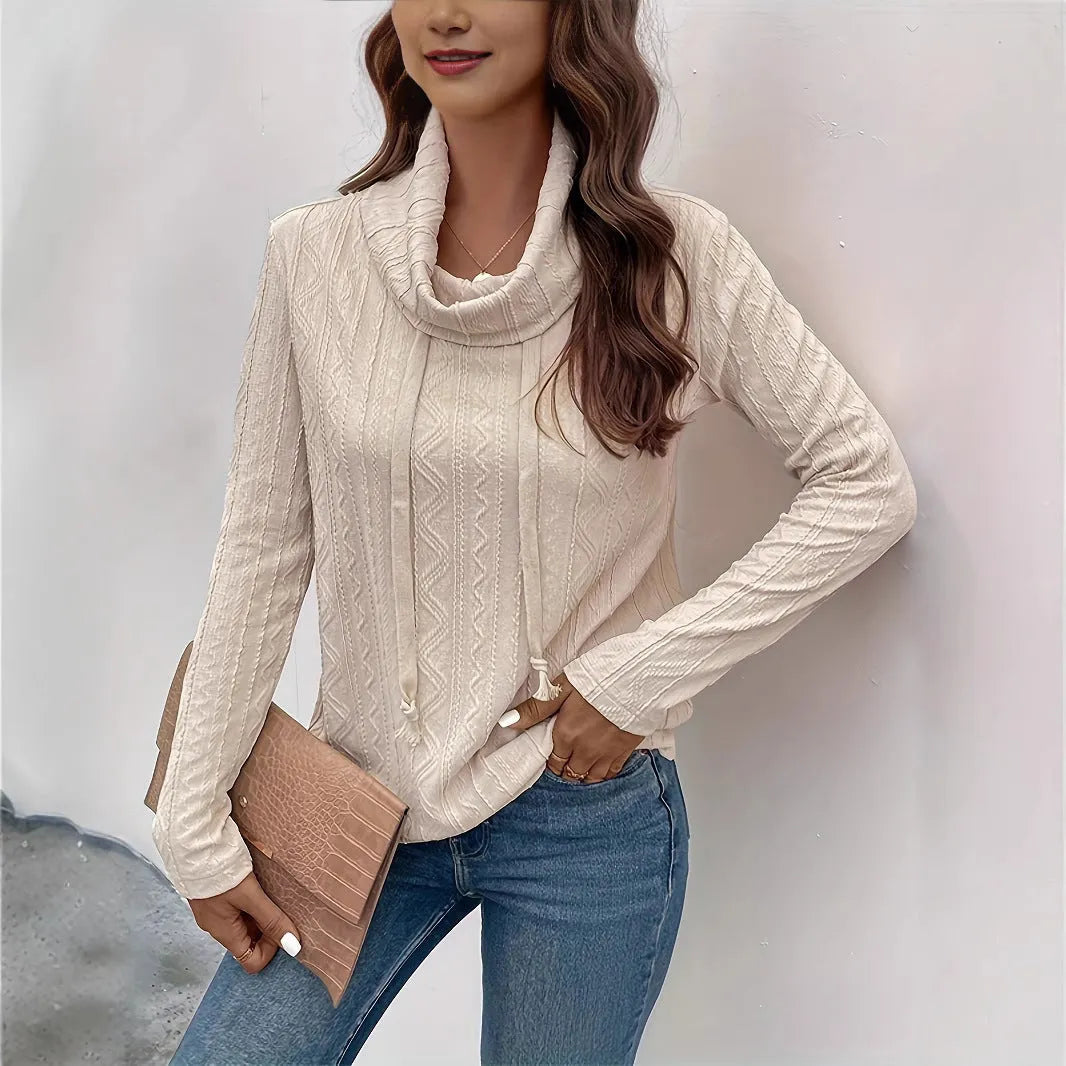 Apricot coloured hooded pullover sweater with long sleeves and a drawstring on the hood.