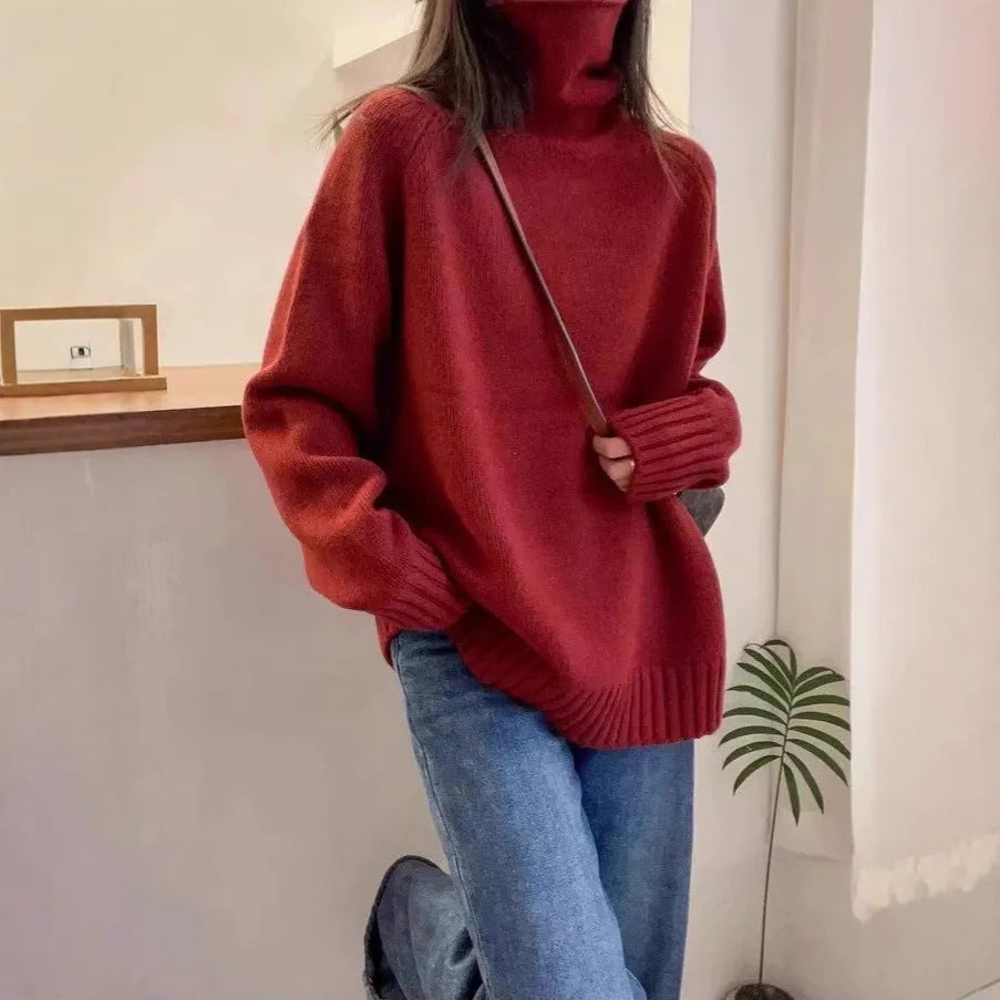 Women's thick turtleneck sweater in solid color with loose casual fit and curled pile collar detail, available in red, camel, gray, and black