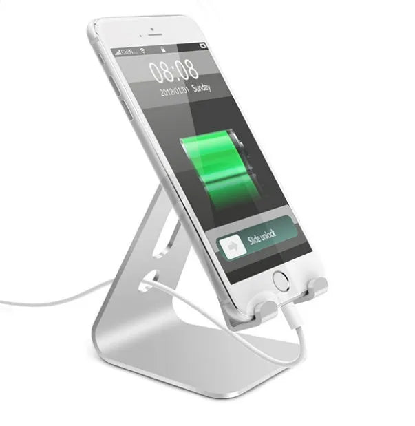 Aluminium alloy universal phone and tablet stand in silver colour on a wooden desk.
