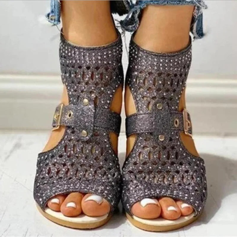 Women's beige flat sandals with a back zipper and a low wedge heel.