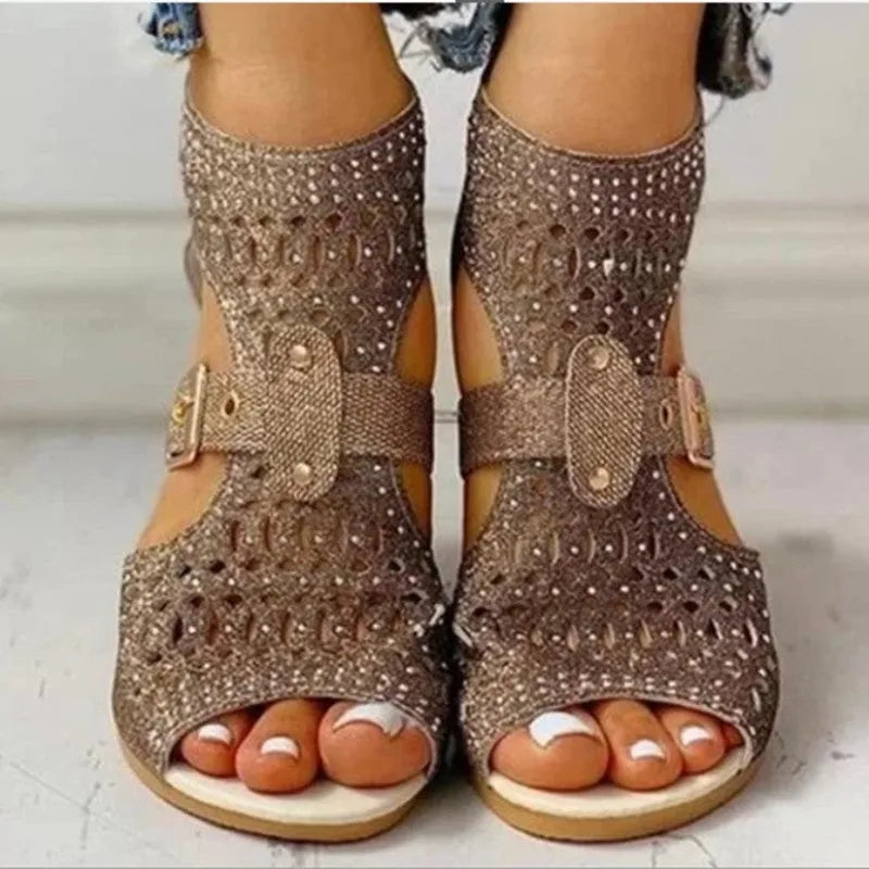 Women's beige flat sandals with a back zipper and a low wedge heel.