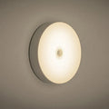 White USB rechargeable motion sensor night light with 86mm diameter showing LED light beads